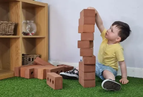 boy playing with bricks